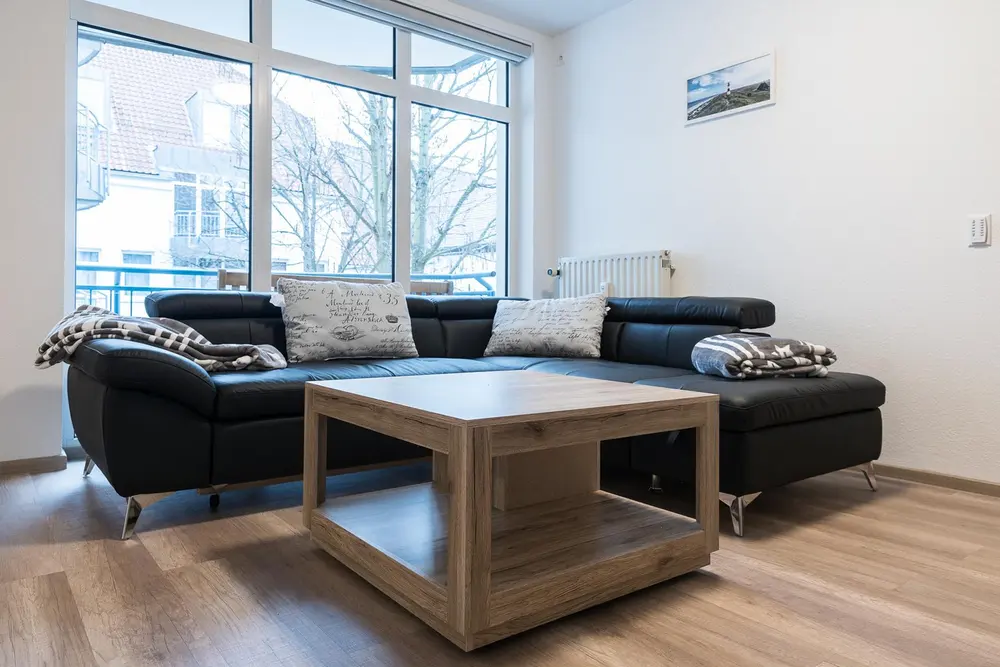 Corner sofa and coffee table in front of the large windows