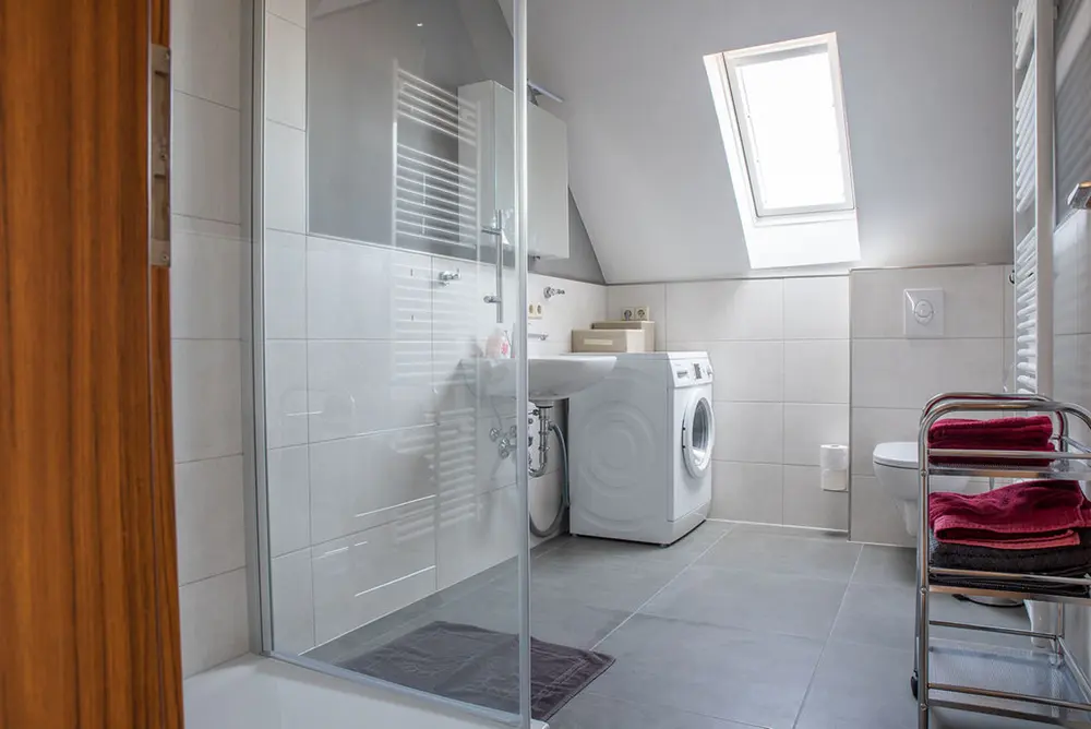 Bathroom with shower and washing machine