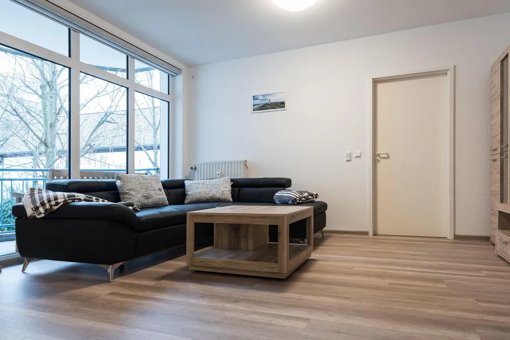 Living room with leather corner sofa and wooden coffee table in the Kaiserslautern apartment